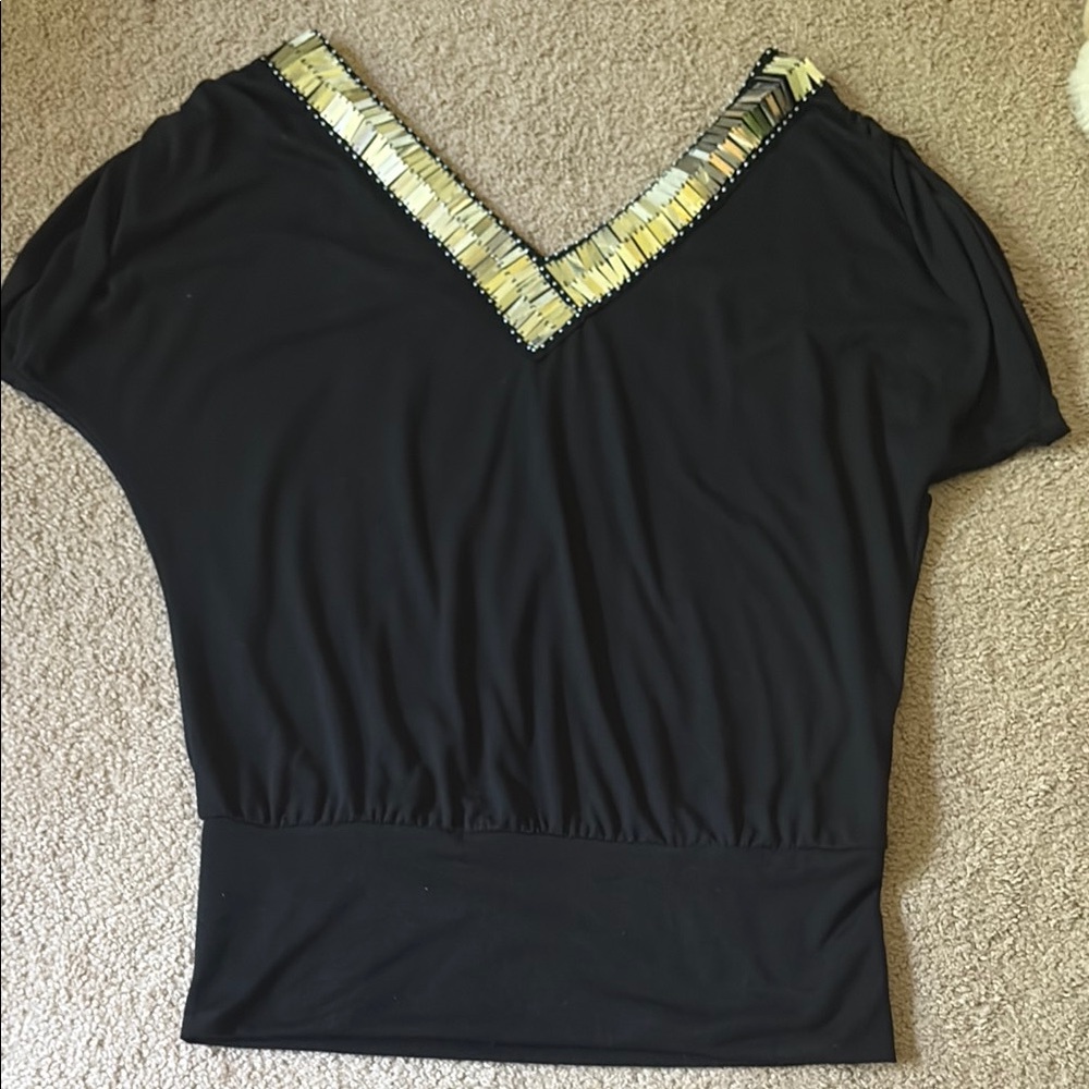 Elegant Black Top with Gold Accents
